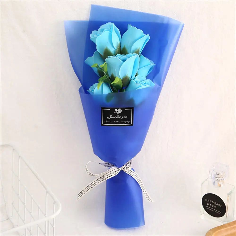 A blue handcrafted soap rose bouquet in a blue paper cone with a silver ribbon.