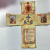 Handcrafted pocket shrine featuring a cross design with decorative elements and text.