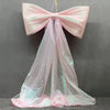 Pink satin bow with long sheer tulle drape used for event decoration