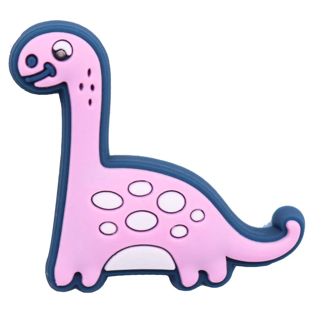 A pink cartoon dinosaur PVC shoe charm with a blue outline and a small snout.