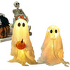 A set of lighted Halloween ghost decorations, including a skeletal figure and a glowing white ghost.
