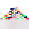A pyramid display of colorful satin ribbon rolls in various shades of pink, blue, green, and yellow.