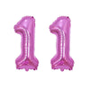 Two shiny rose gold foil number balloons shaped like the number one for birthday party decor
