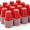 A stack of fifty red disposable shot glasses with white striped bases.