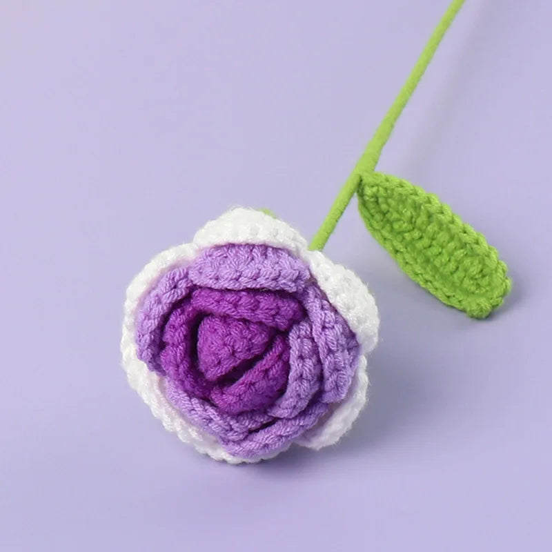 Handmade crochet tulip bouquet featuring purple and white flowers on a green stem