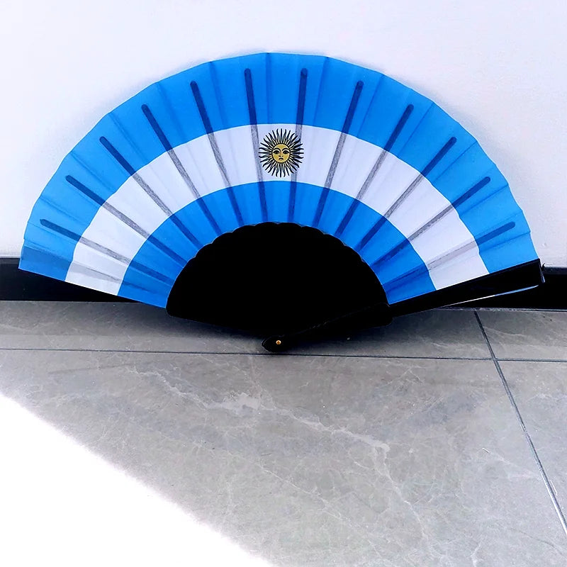 A handheld folding fan featuring a blue and white design with a sun emblem.