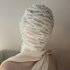White mesh balaclava face mask worn on a person's head and neck.