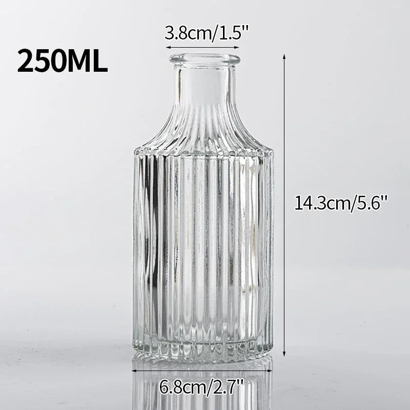 A clear glass bottle with a narrow neck, measuring 250ml, used for various decorative purposes.