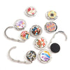 A collection of foldable handbag hooks featuring various floral and geometric designs in silver metal.