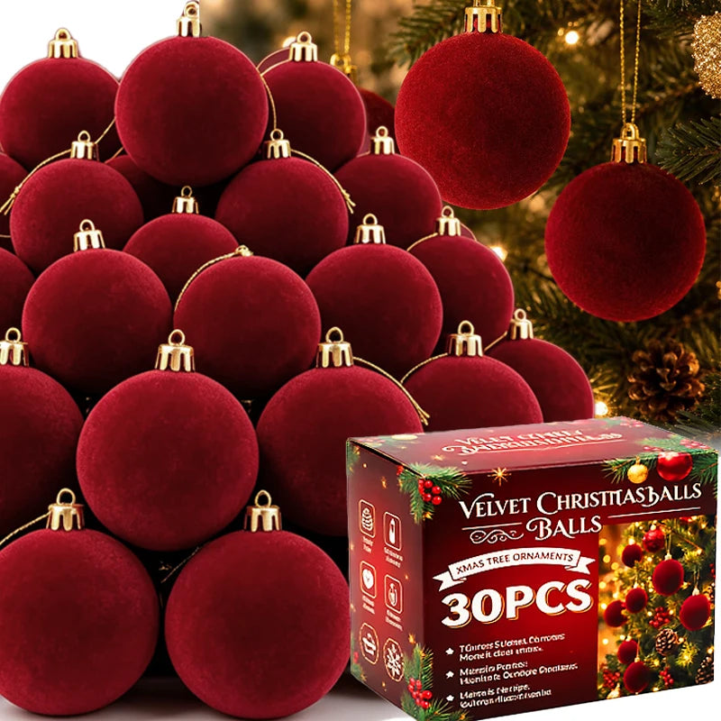 A close-up view of a set of 30 deep red velvet flocked Christmas ball ornaments hanging on a green pine branch.