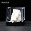 A rough white crystal specimen is displayed inside a clear acrylic box.