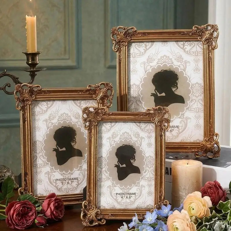 A gold-framed photo of a silhouette, set among roses and blue flowers.