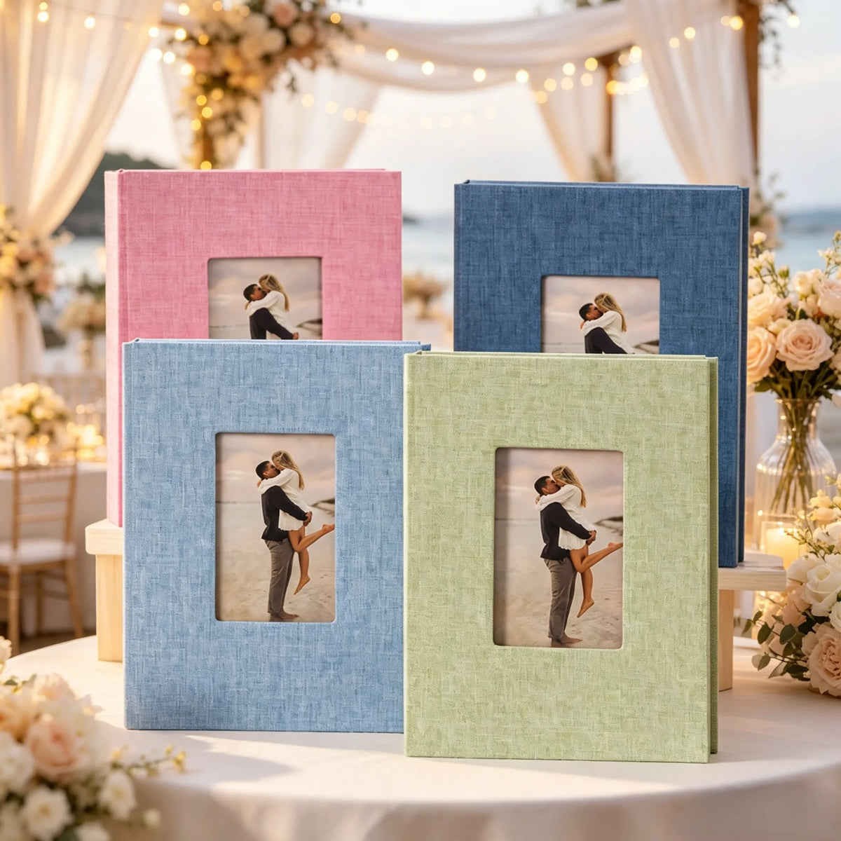 A display of linen photo albums in various shades of blue, pink, and green set up for an event.