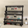 A black wooden multilayer organizer displaying various silver and colored earrings and jewelry.