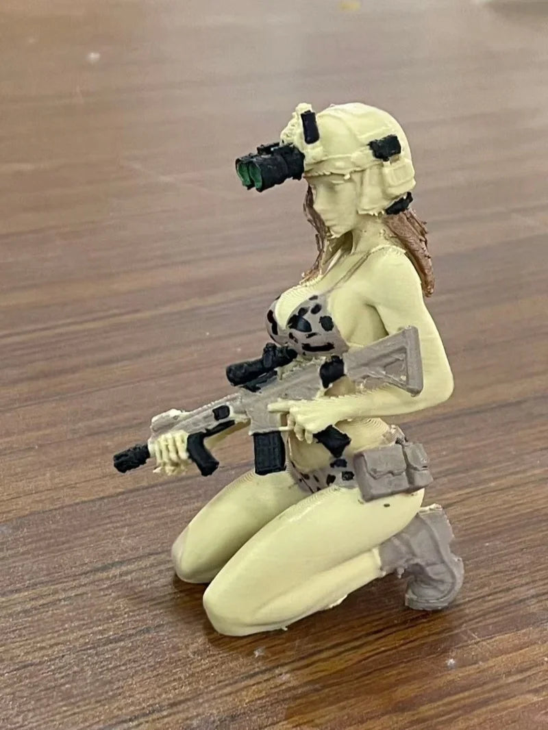 A female rifleman desktop figurine with a headset and holding an assault rifle.