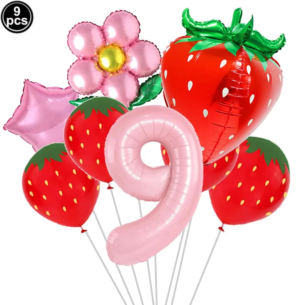 A set of nine pink and red strawberry balloons, including a large strawberry balloon and a number balloon.