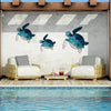 Rustic iron wall art featuring three teal and blue sea turtle sculptures displayed in a modern outdoor setting.