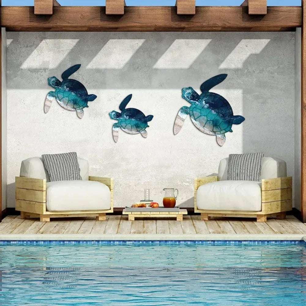 Rustic iron wall art featuring three teal and blue sea turtle sculptures displayed in a modern outdoor setting.