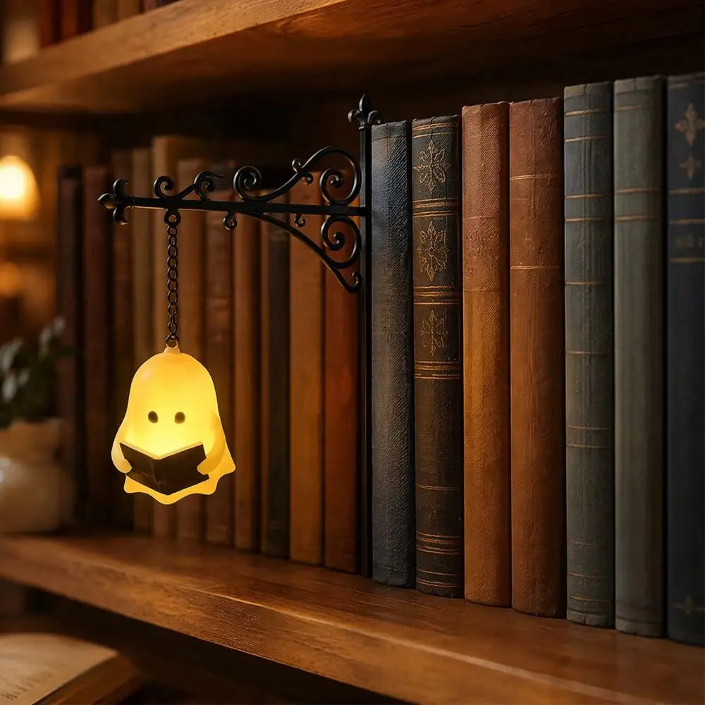 A vintage bookshelf lantern lamp with a yellow glow illuminates a row of old books on a wooden shelf.