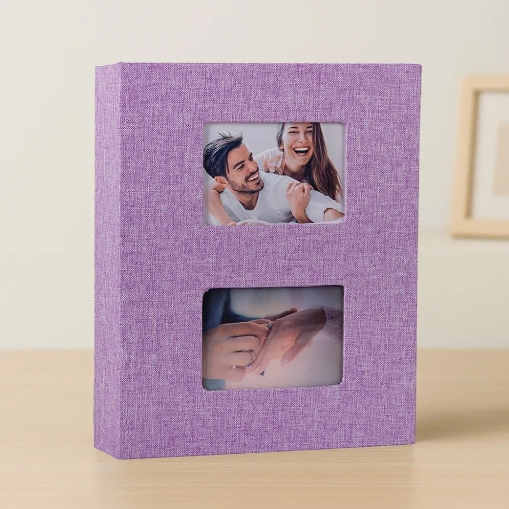 A purple linen-cover photo album with two framed photos inside.