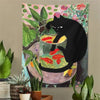 A tapestry featuring a black cat sitting on a bowl filled with goldfish, set against a floral background.