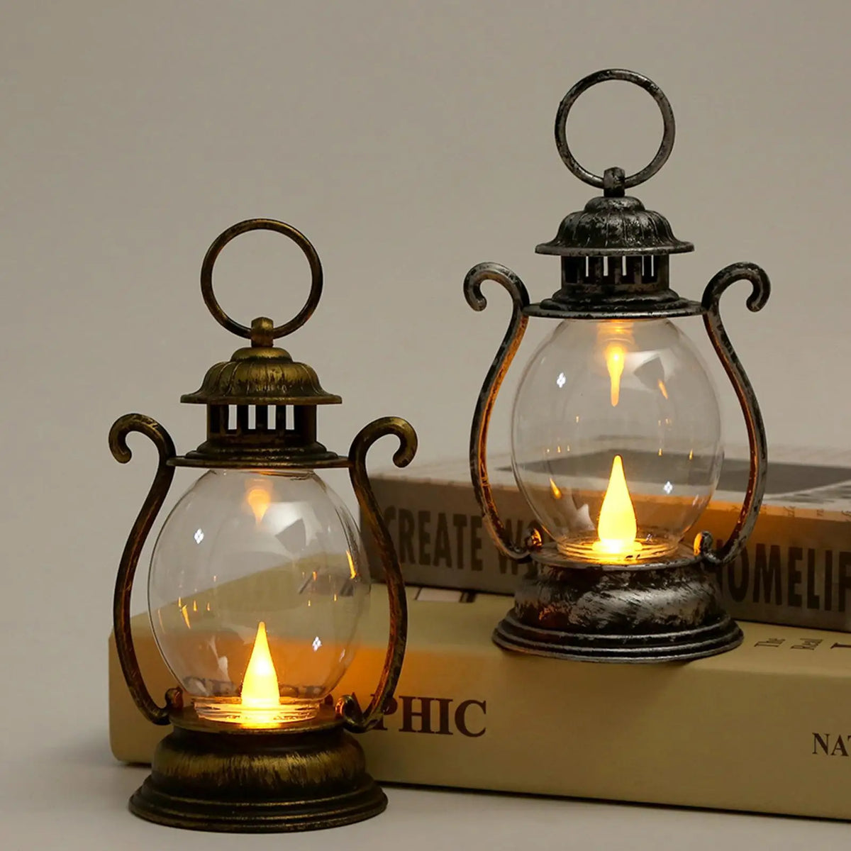 A vintage battery-powered desk lamp with an antique brass and glass design sitting on a stack of books.