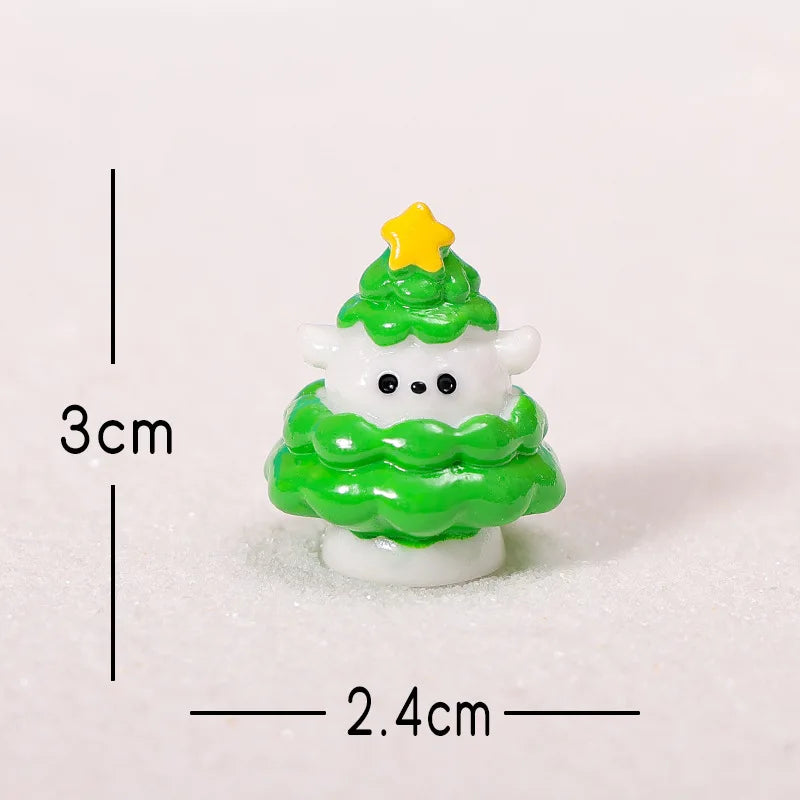 A small green Christmas tree charm with a yellow star topper made of resin