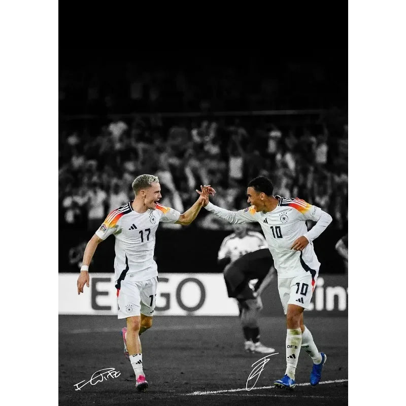 A soccer player in a white jersey and shorts is celebrating on the field during a match.