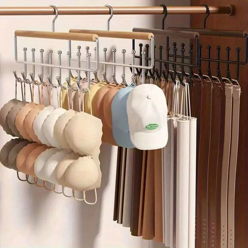 Wall-mounted metal coat rack with storage box and eight hooks displaying various colored coats and jackets.