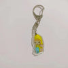 Silver acrylic keychain featuring a yellow banana cat figurine.