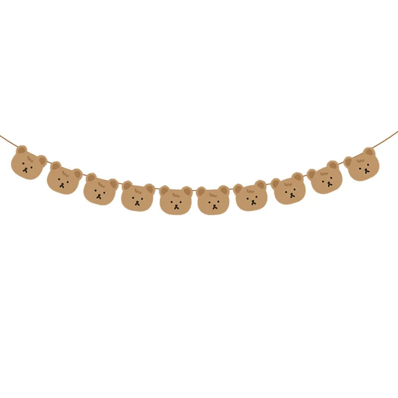 A string of cute brown teddy bear heads forming a banner for a birthday party.