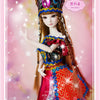 A detailed ball-jointed doll with long brown hair wearing a colorful, ornate costume and a jeweled crown.