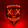 A glowing orange LED mask shaped like a stylized, menacing face with crisscrossing lines and a wide grin.