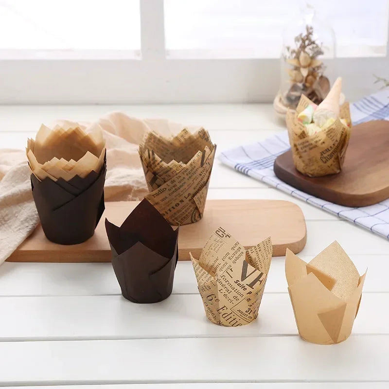 A collection of brown and tan newspaper style cupcake liners arranged on a light wooden surface.