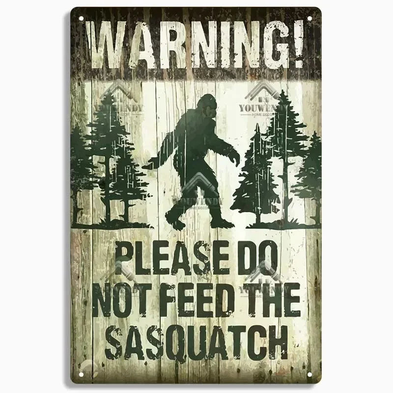 A weathered wooden sign with the text WARNING PLEASE DO NOT FEED THE SASQUATCH.