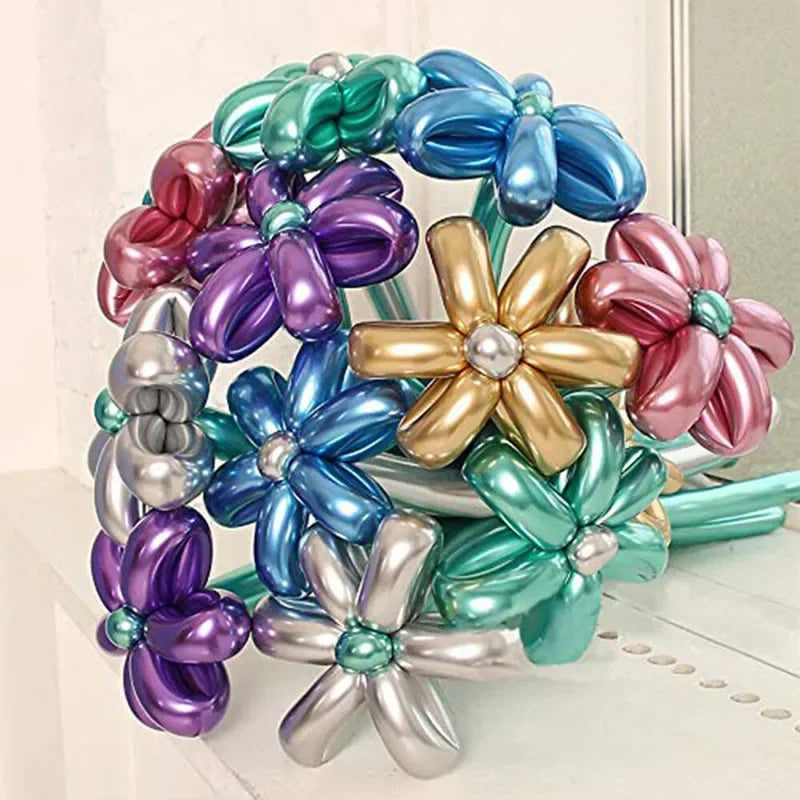 A cluster of glossy latex modeling balloons in shades of purple, blue, and pink arranged for party decor.