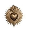 A golden wall plaque featuring a radiant sunburst design surrounding an engraved heart.