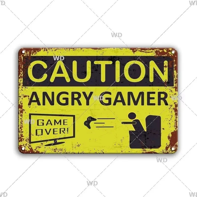 A vintage industrial tin sign with a distressed yellow background featuring the text CAUTION ANGRY GAMER GAME OVER!