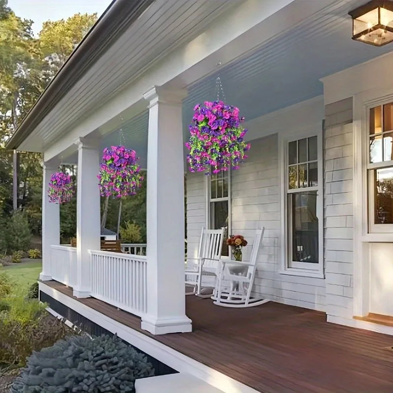 A porch decorated with white columns and purple silk peony hanging garlands on a wooden deck.