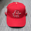 A red baseball cap embroidered with a silver star logo and white stitching on the sides.