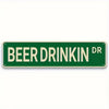 Green metal tin sign with white text that reads BEER DRINK DR