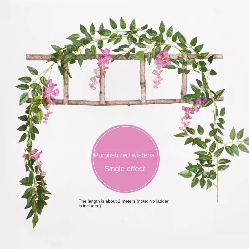 A silk wisteria vine garland with purple-pink flowers draped over a wooden trellis.