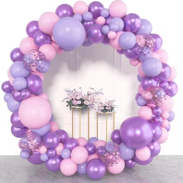 A balloon garland featuring shades of purple and pink balloons with gold accents.