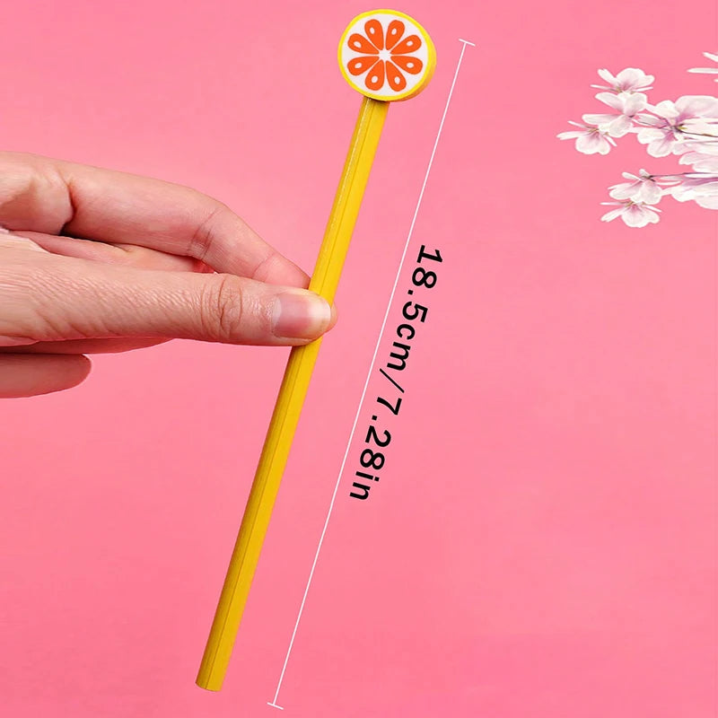 A hand holds a yellow pencil with an orange flower eraser top, demonstrating its size.
