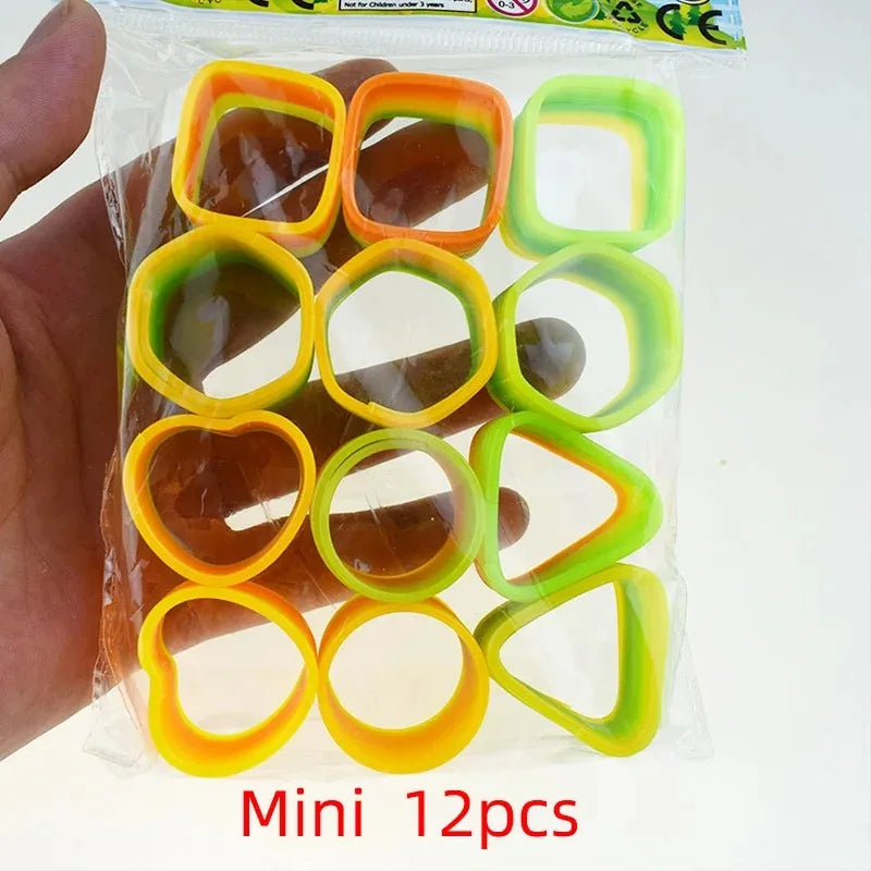 A hand holds a clear plastic bag containing 12 colorful spring toys for children.