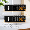 A digital LED alarm clock displaying the time 1:03 and temperature 26 degrees with light adjustment features.