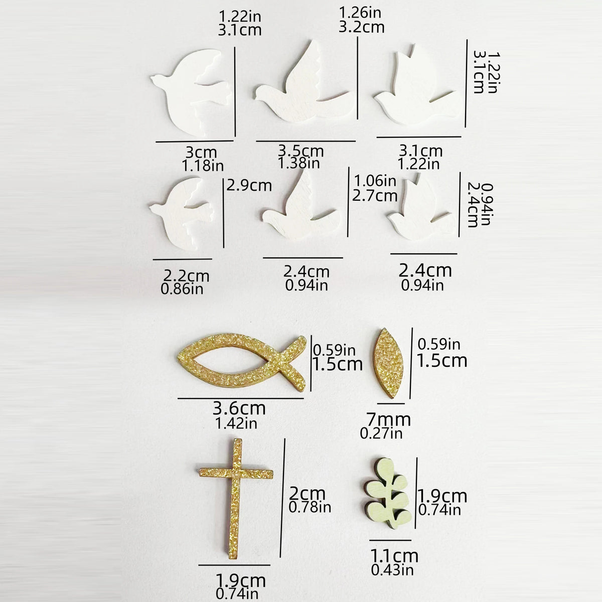 A set of gold glitter faith and celebration party decor including doves, crosses, and leaves.