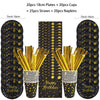A set of black and gold disposable dinnerware including plates, cups, straws, and napkins.