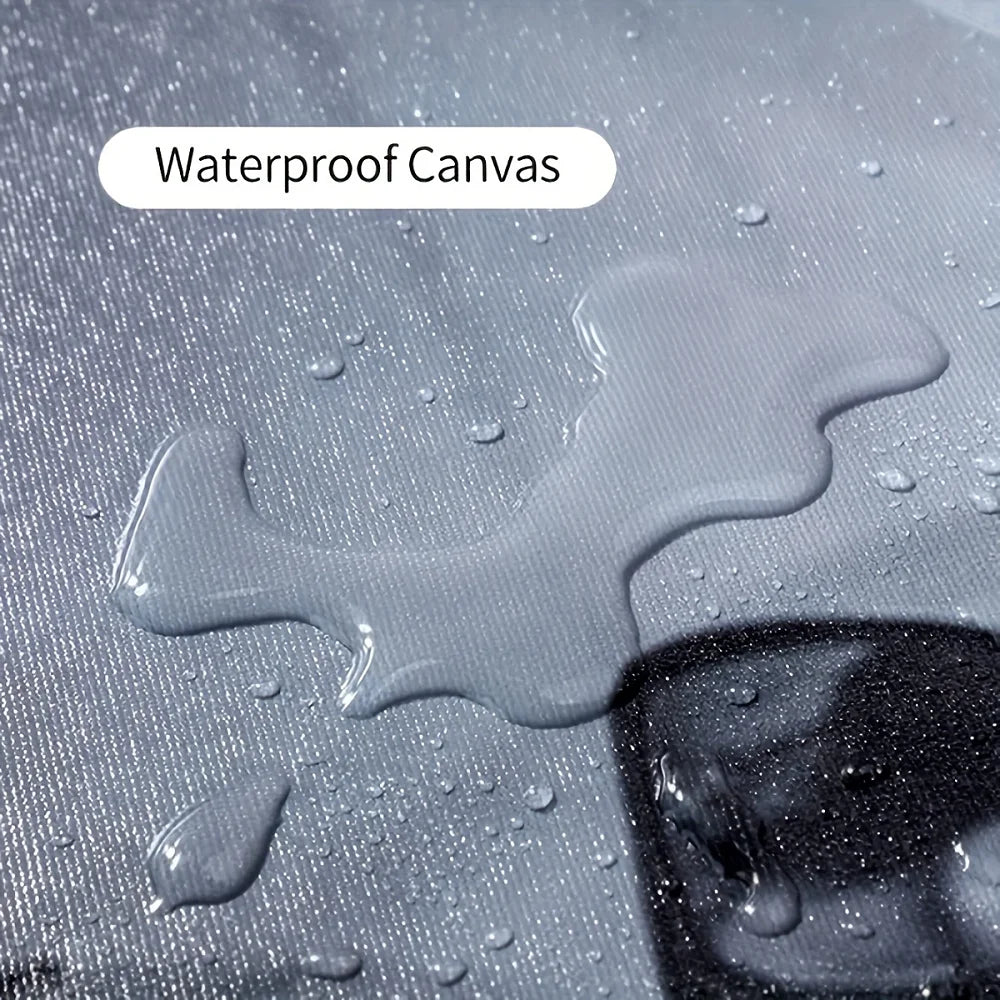 Close-up of waterproof canvas material with water droplets on a dark surface.