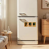 A white refrigerator features three vintage style wooden magnets depicting playful black cat art.